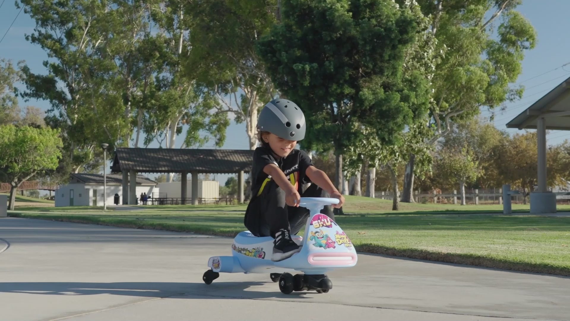 A video shows a boy, probably 6 or 7 years old, riding a 6KU scooter on a safe, deserted neighborhood street, demonstrating the drifting function of the Momo Drift 11 Pro Electric Wiggle Car.